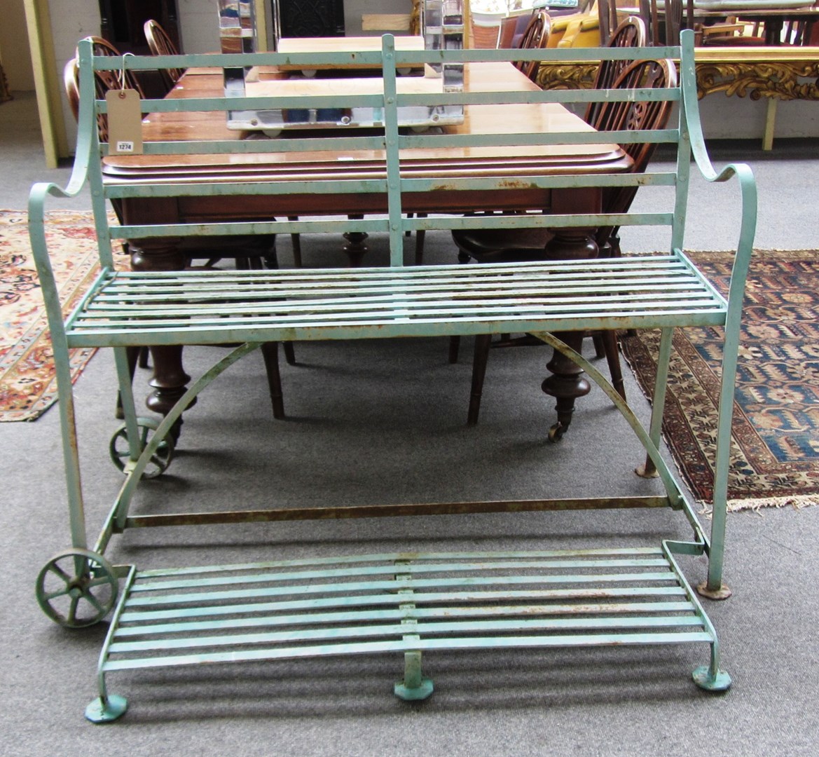 Appraisal: An early th century green painted wrought iron garden bench