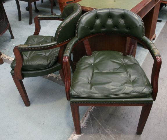 Appraisal: A pair of green leather button back upholstered armchairs