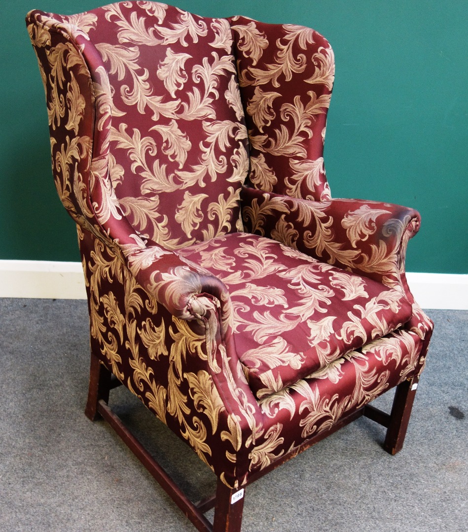 Appraisal: A th century wingback armchair of th century design on