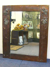 Appraisal: A copper framed Art Nouveau mirror embossed with stylised leaf