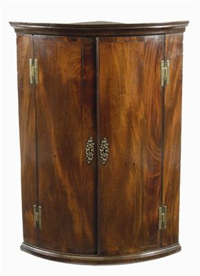 Appraisal: A George III mahogany bowfront hanging corner cupboard the interior