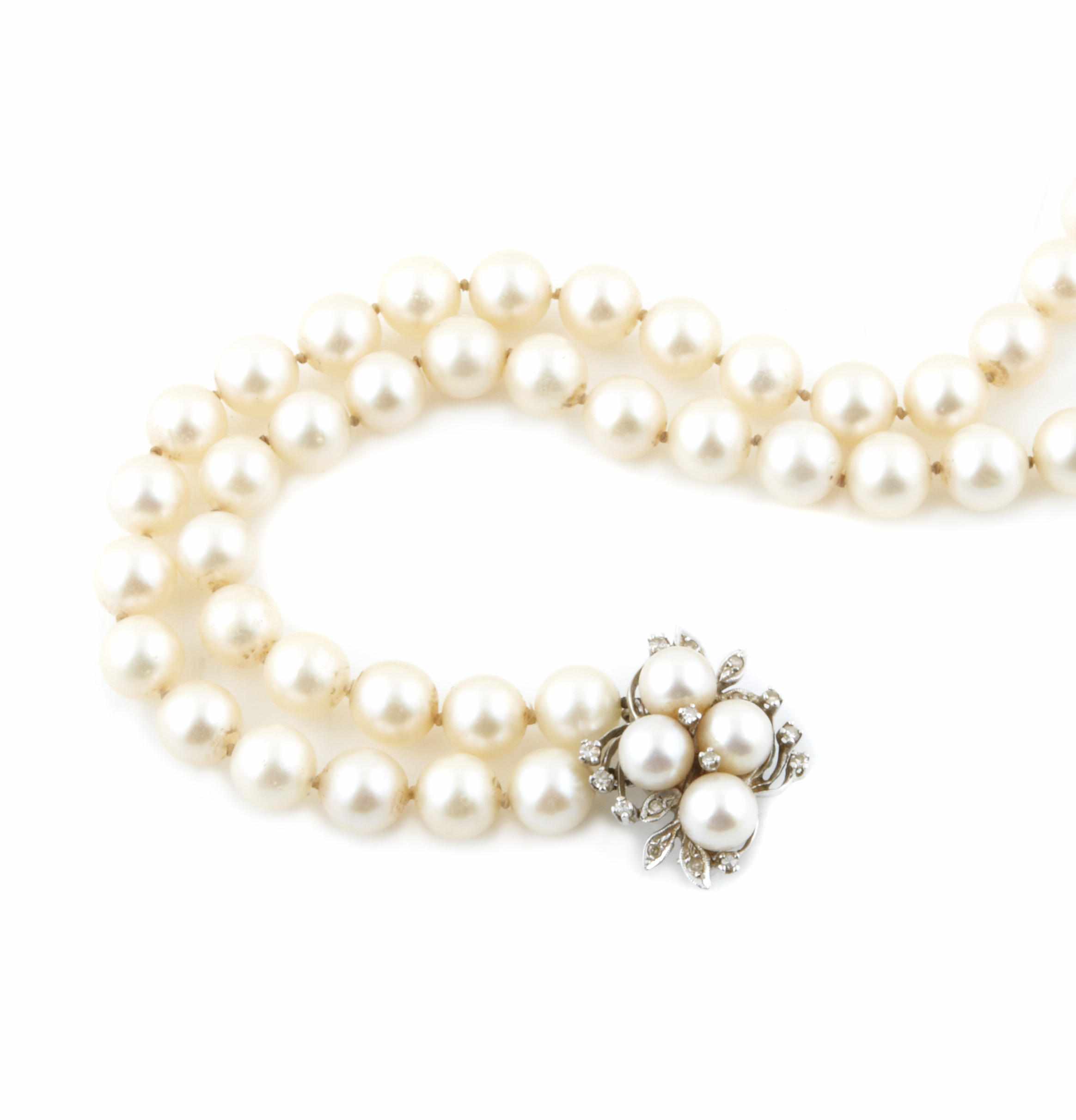 Appraisal: A double strand cultured pearl necklace with diamond and white