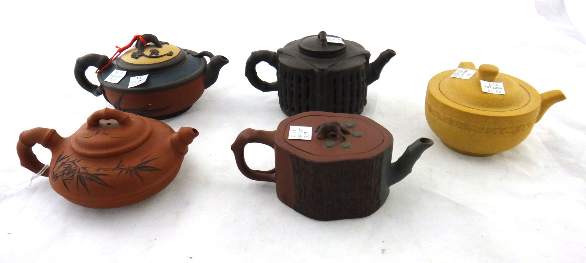 Appraisal: A group of five Chinese stoneware teapots and covers th