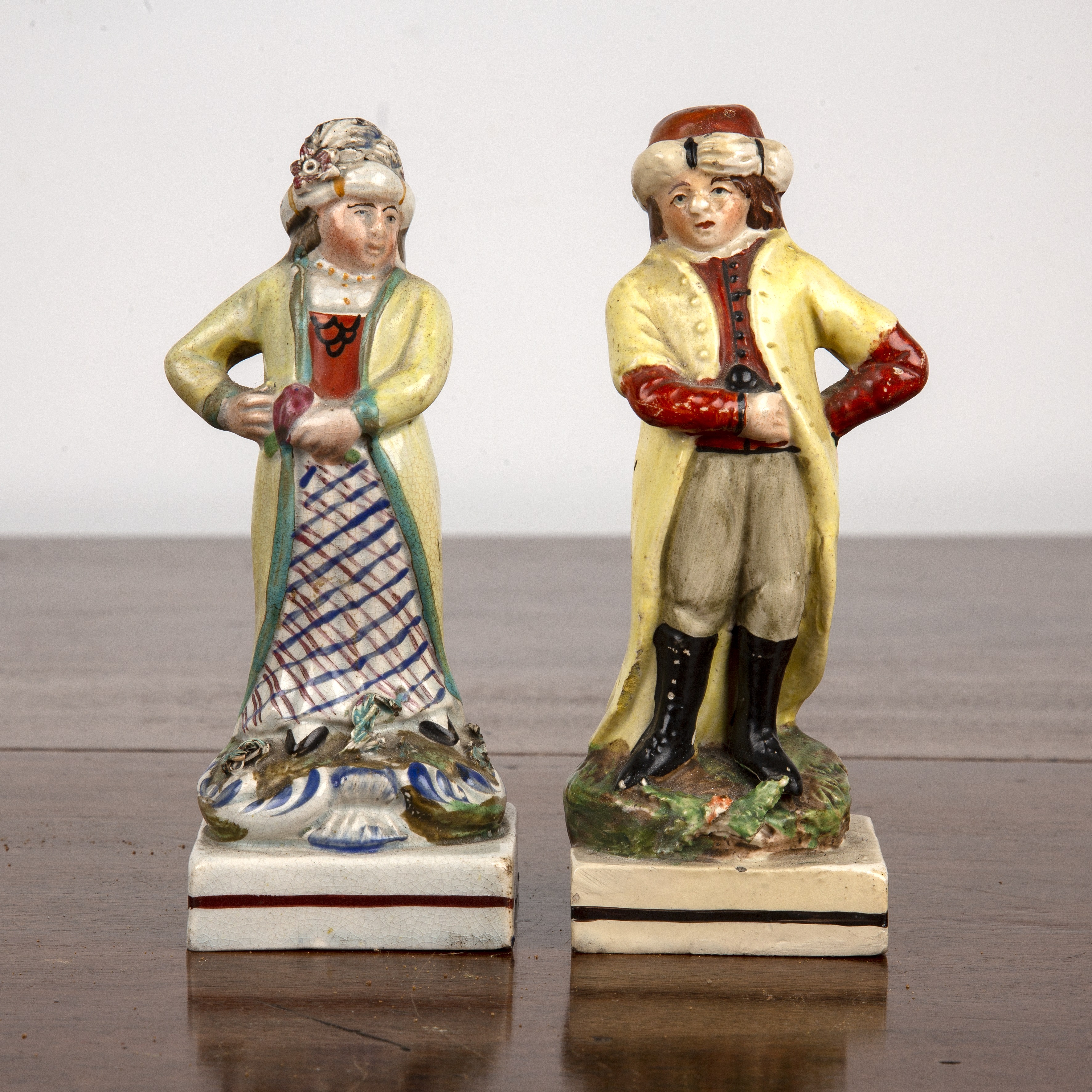 Appraisal: Pair of creamware figures th Century each wearing a yellow