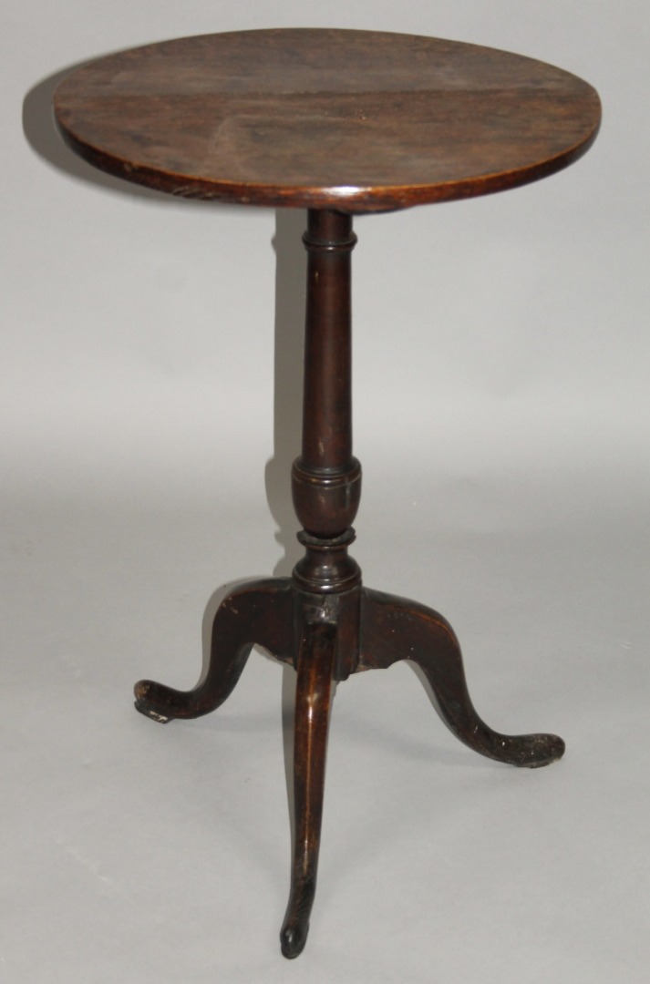 Appraisal: A thC oak occasional table the plain circular top on