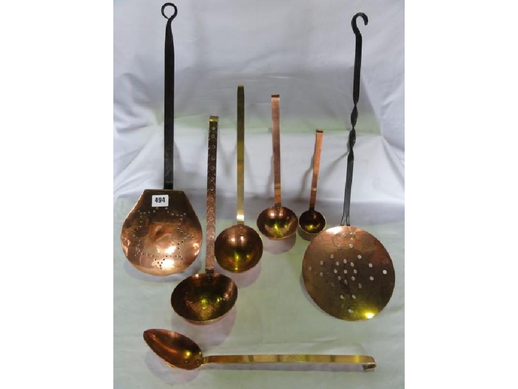 Appraisal: A collection of graduated copper ladles a skimmer and chestnut