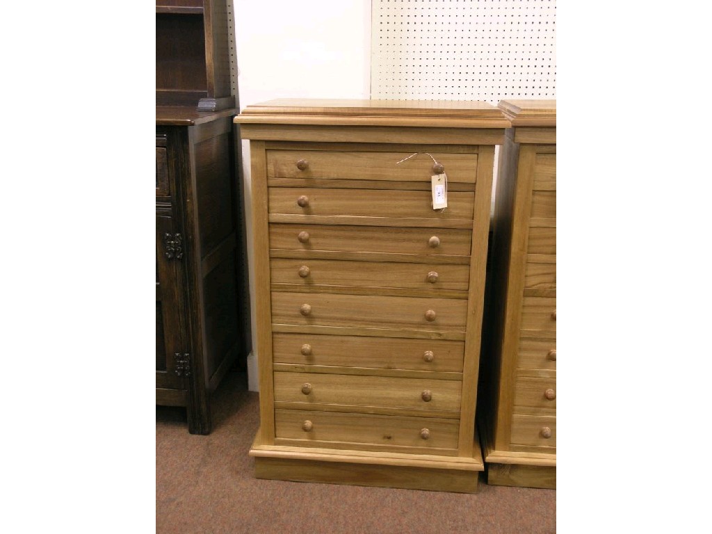 Appraisal: A reproduction pale mahogany Wellington chest eight drawers each with