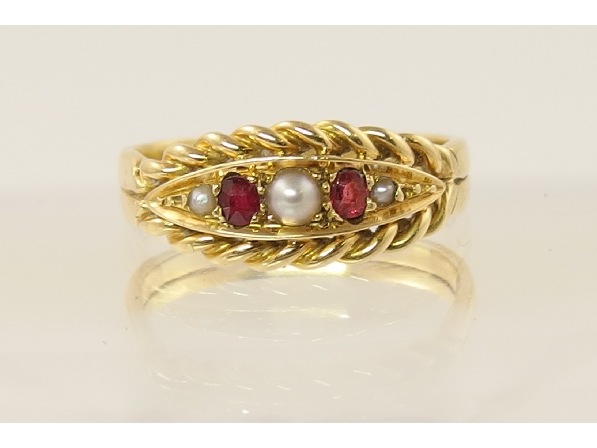 Appraisal: A Victorian yellow metal ruby and pearl ring with a