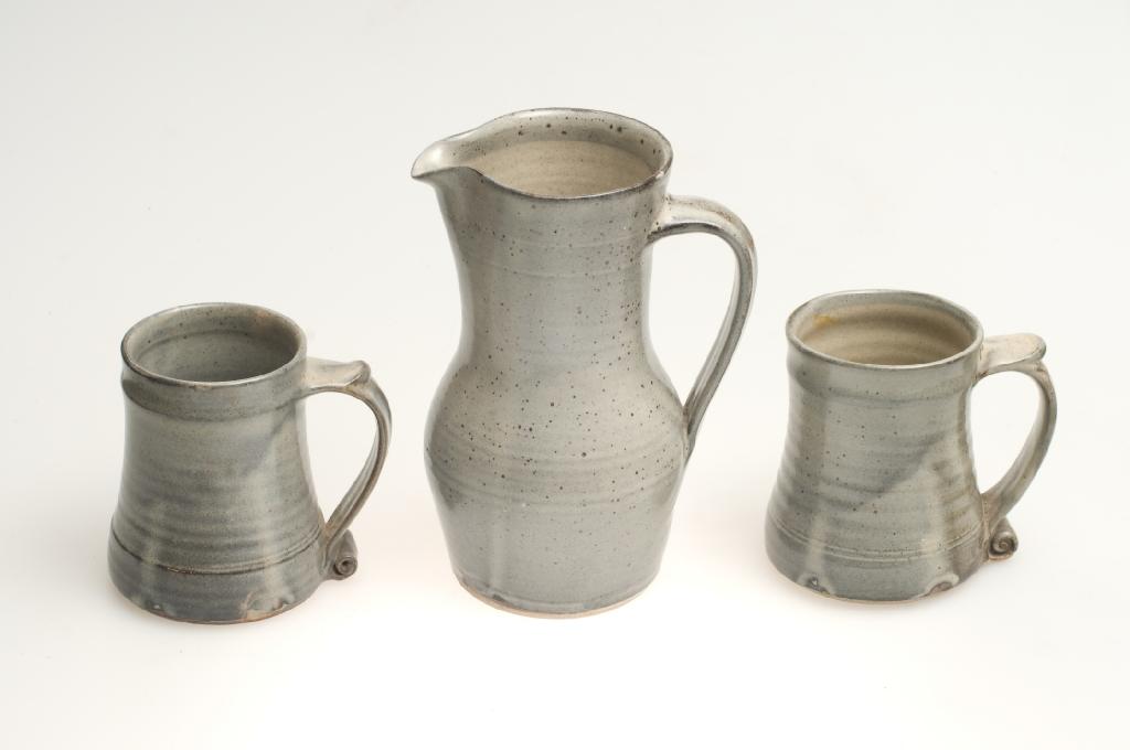 Appraisal: BERNARD LEACH STUDIO POTTERY JUG AND PAIR OF TANKARDS the