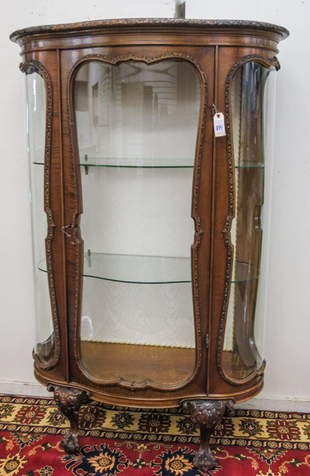 Appraisal: CHIPPENDALE STYLE CURVED GLASS AND CARVED WALNUT CHINA DISPLAY CABINET