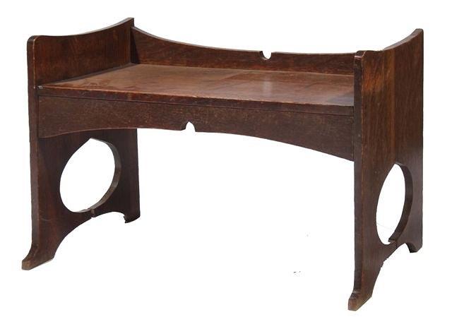 Appraisal: AN ARTS AND CARFTS OAK BENCH with solid seat and