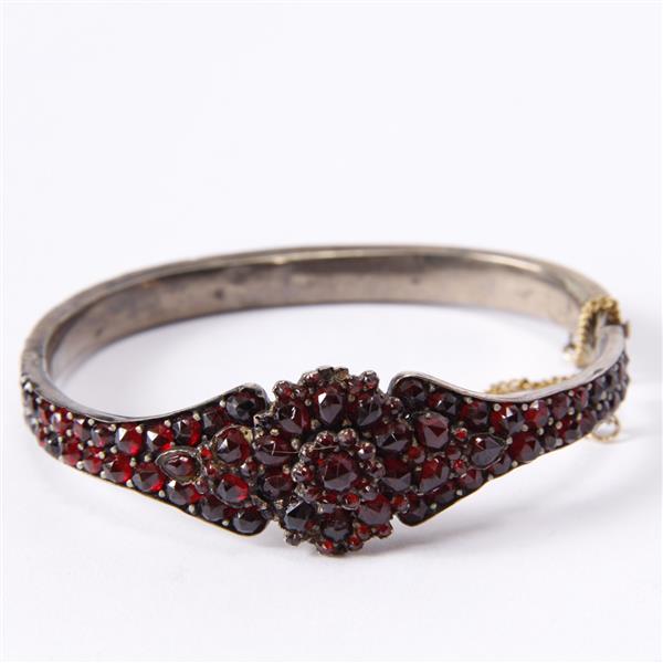 Appraisal: Antique Victorian hinged garnet bangle bracelet widest point inner width