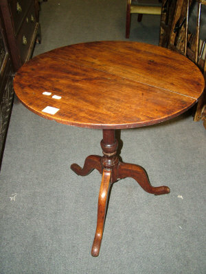 Appraisal: A mahogany tripod table th century the circular top upon