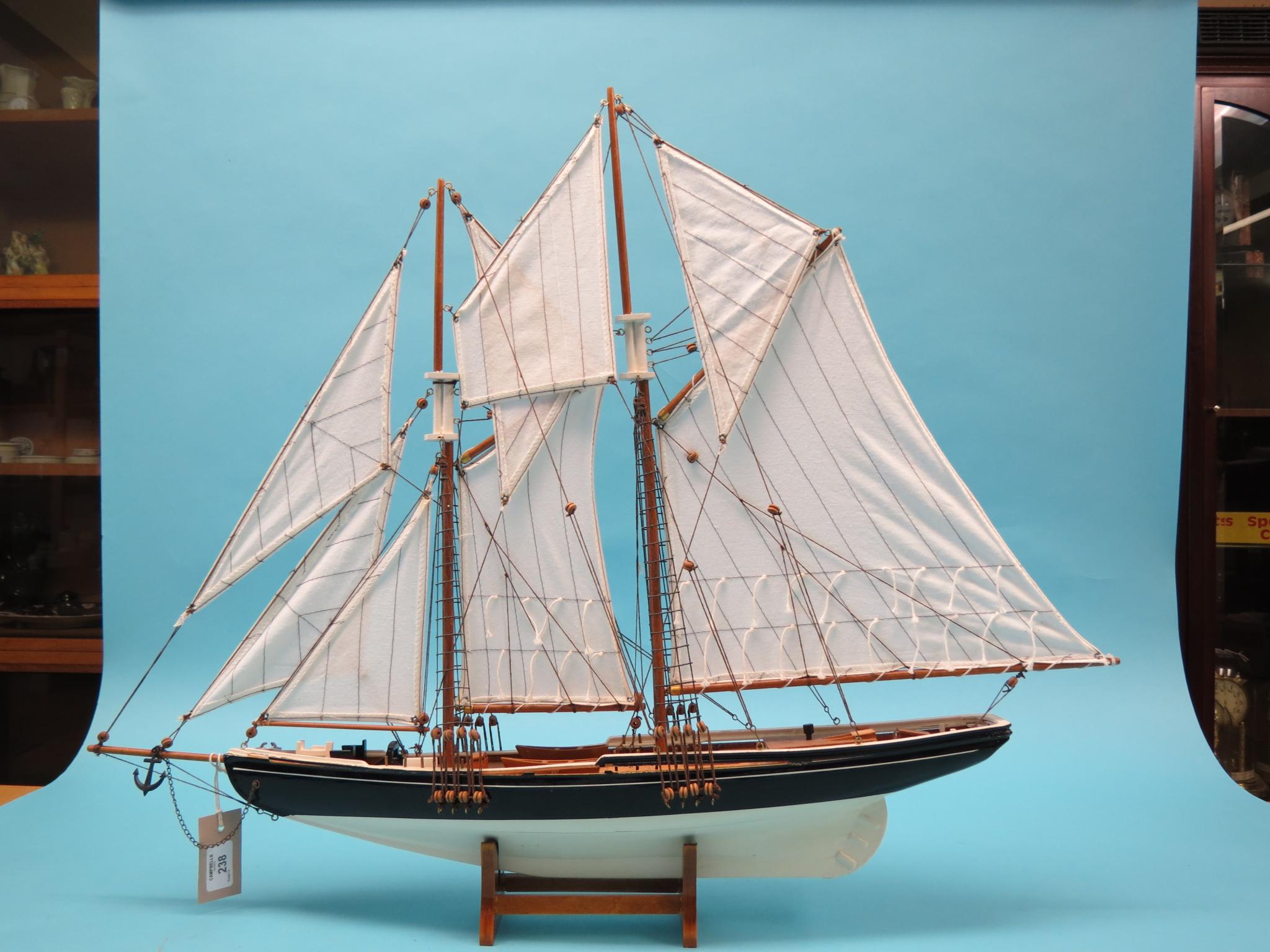 Appraisal: A model sailing boat twin-masted and fully rigged with sails