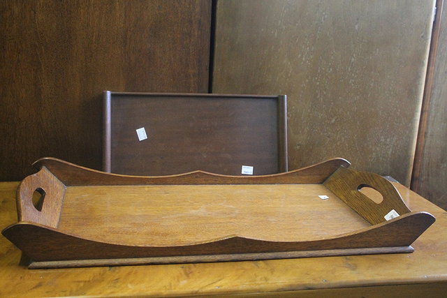 Appraisal: AN OAK TRAY by Arthur Simpson of Kendal with shaped