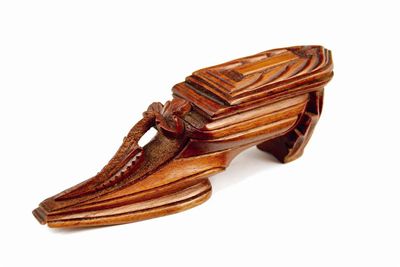 Appraisal: A carved Black Forest treen snuff shoe with a hinged