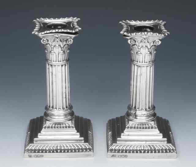 Appraisal: A PAIR OF LATE VICTORIAN SILVER CANDLESTICKS with corinthian columns