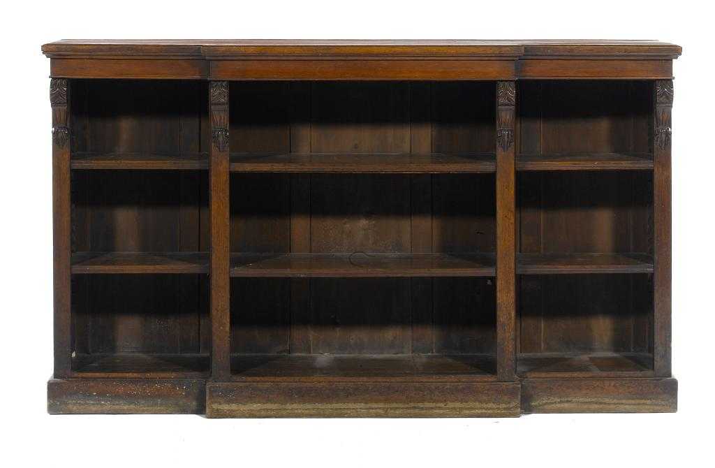 Appraisal: A VICTORIAN OAK BREAKFRONT OPEN BOOKCASE with leaf carved corbels