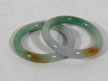 Appraisal: A pair of jadeite bangles apparently cut from the same