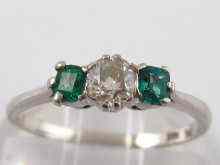 Appraisal: A three stone diamond and emerald ring set in white