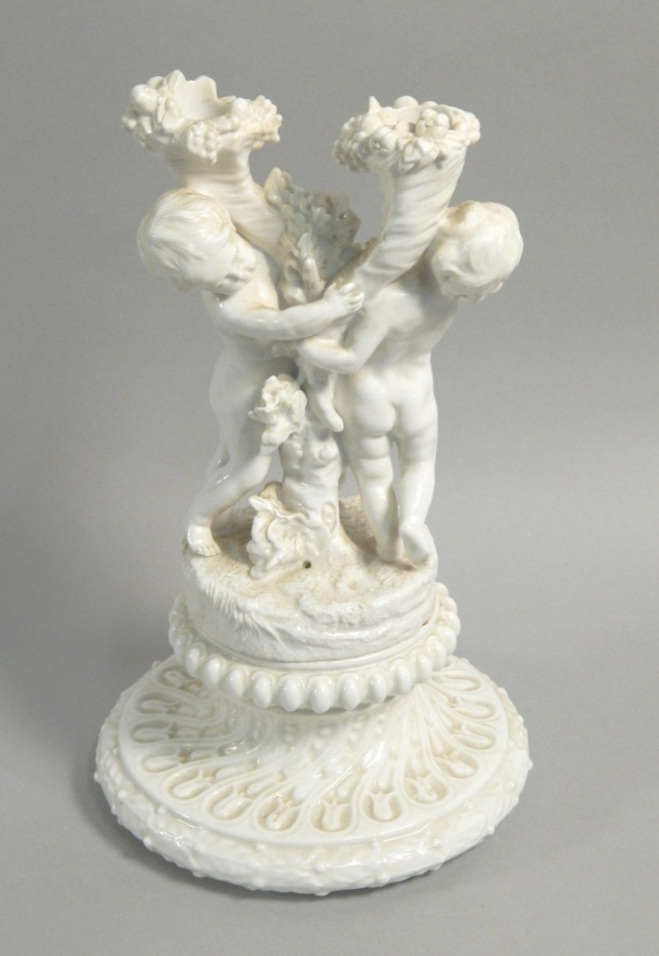 Appraisal: A thC porcelain two branch candelabra mounted with Putti the