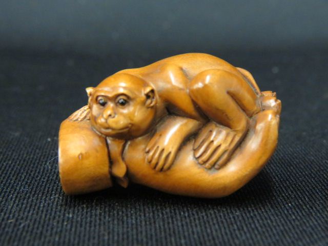 Appraisal: Carved Wood Netsuke of a Monkey in buddhas hand onyx