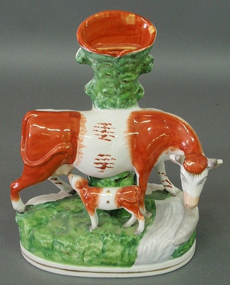 Appraisal: Staffordshire cow bank in spill vase form signed Geo Borgfeldt