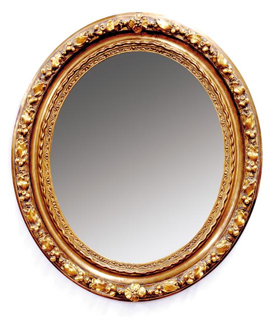 Appraisal: Continental carved giltwood oval mirror late th century heavy molded