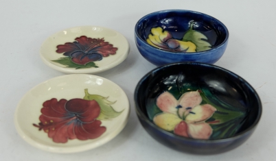 Appraisal: Moorcroft small dishes decorated in Hibiscus and Clematis designs