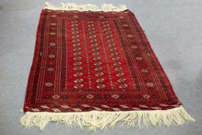 Appraisal: A Turkoman rug the red field with three rows of