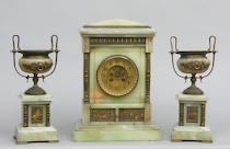 Appraisal: A Three-Piece Clock Garniture Set A three-piece clock garniture set