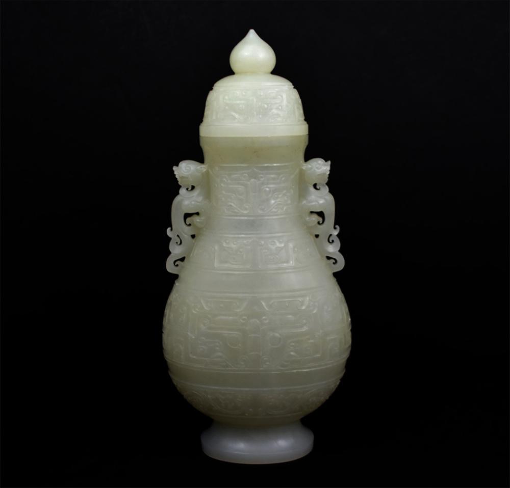 Appraisal: CHINESE WHITE JADE COVERED VASEThe archaistic translucent jade vase with