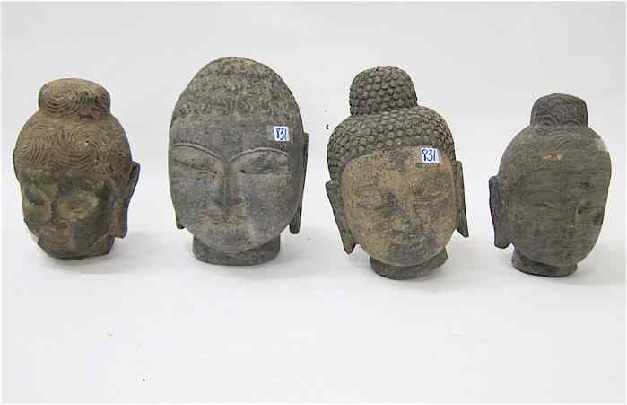 Appraisal: FOUR SCULPTED GRANITE BUDDHA HEADS all have downcast eyes elongated