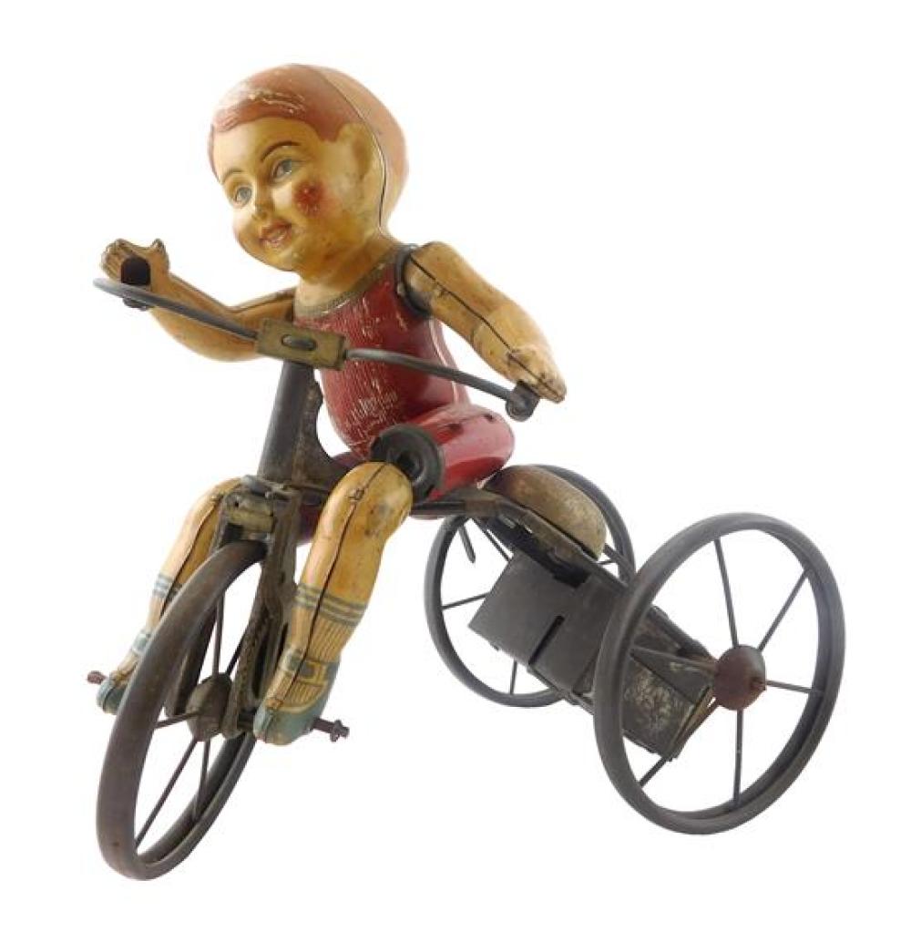 Appraisal: TOY Tin lithograph wind-up boy on tricycle toy early to