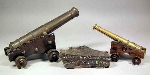 Appraisal: An early Victorian bronze model of a cannon on oak