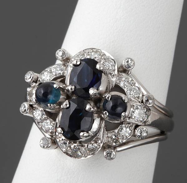 Appraisal: A sapphire diamond and platinum ring centering two round sapphire