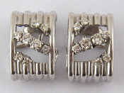 Appraisal: A pair of white metal tests carat gold diamond earrings