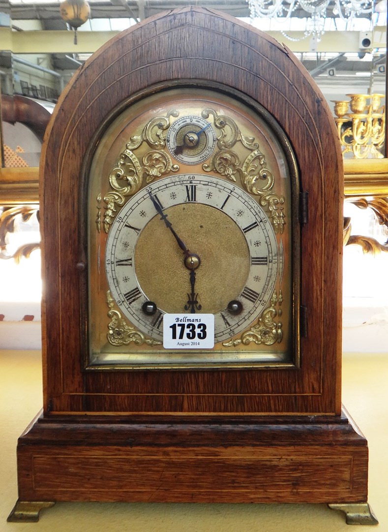 Appraisal: A German oak cased quarter striking mantel clock early th