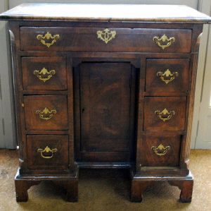 Appraisal: A George III cross-banded walnut kneehole desk the moulded edge