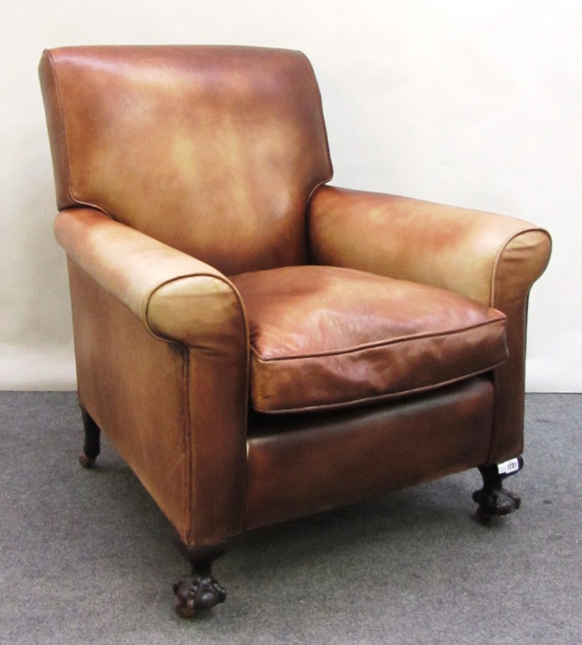 Appraisal: An early th century brown leather upholstered club armchair on