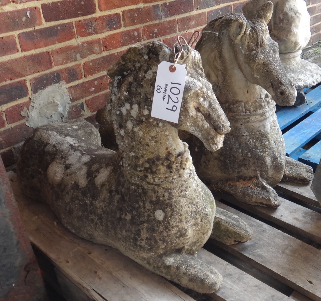 Appraisal: A pair of reconstituted stone figures of horses in recumbant