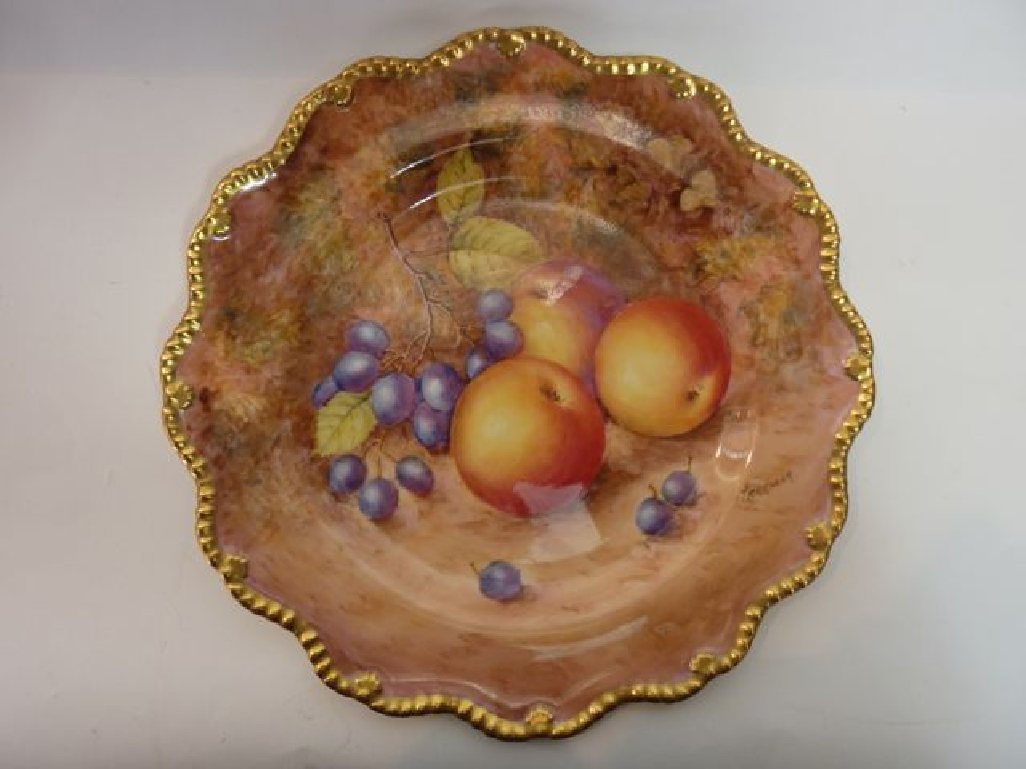 Appraisal: A Royal Worcester cabinet plate with scalloped gilded border and