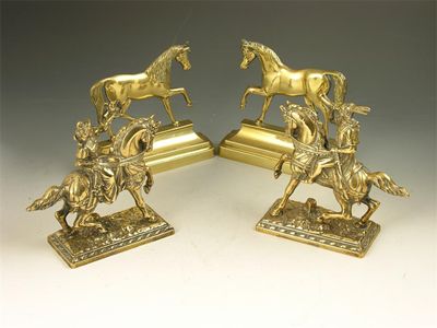 Appraisal: A pair of continental brass hunting equestrian groups of a