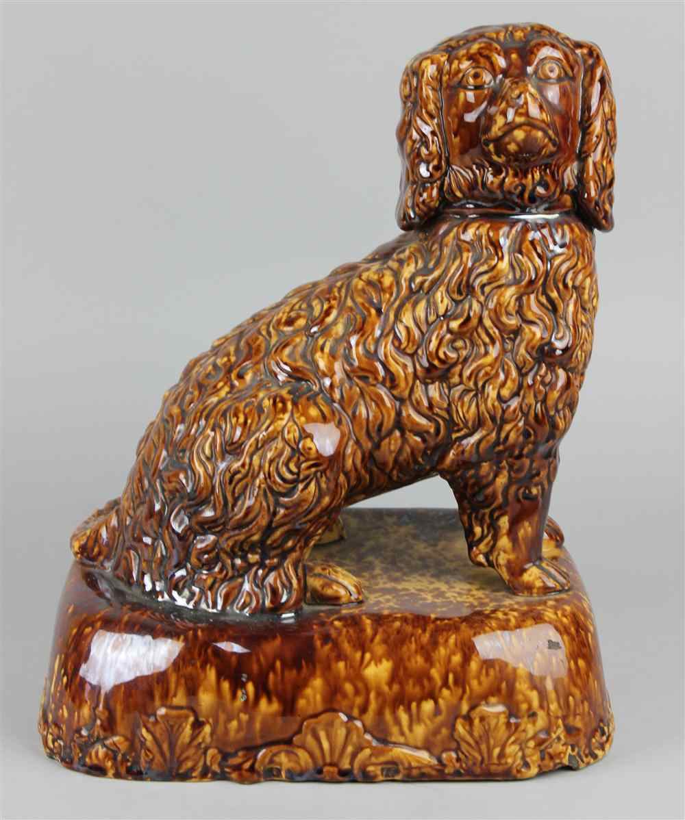 Appraisal: ROCKINGHAM-GLAZED YELLOW WARE MODEL OF A SPANIEL late th century