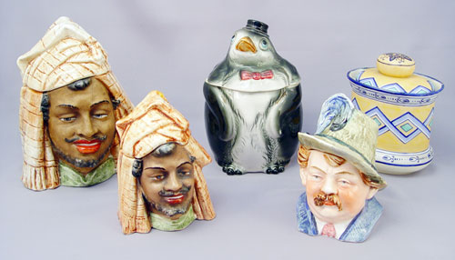 Appraisal: COLLECTION OF FIGURAL TOBACCO JARS Penguin ''h Figural man ''