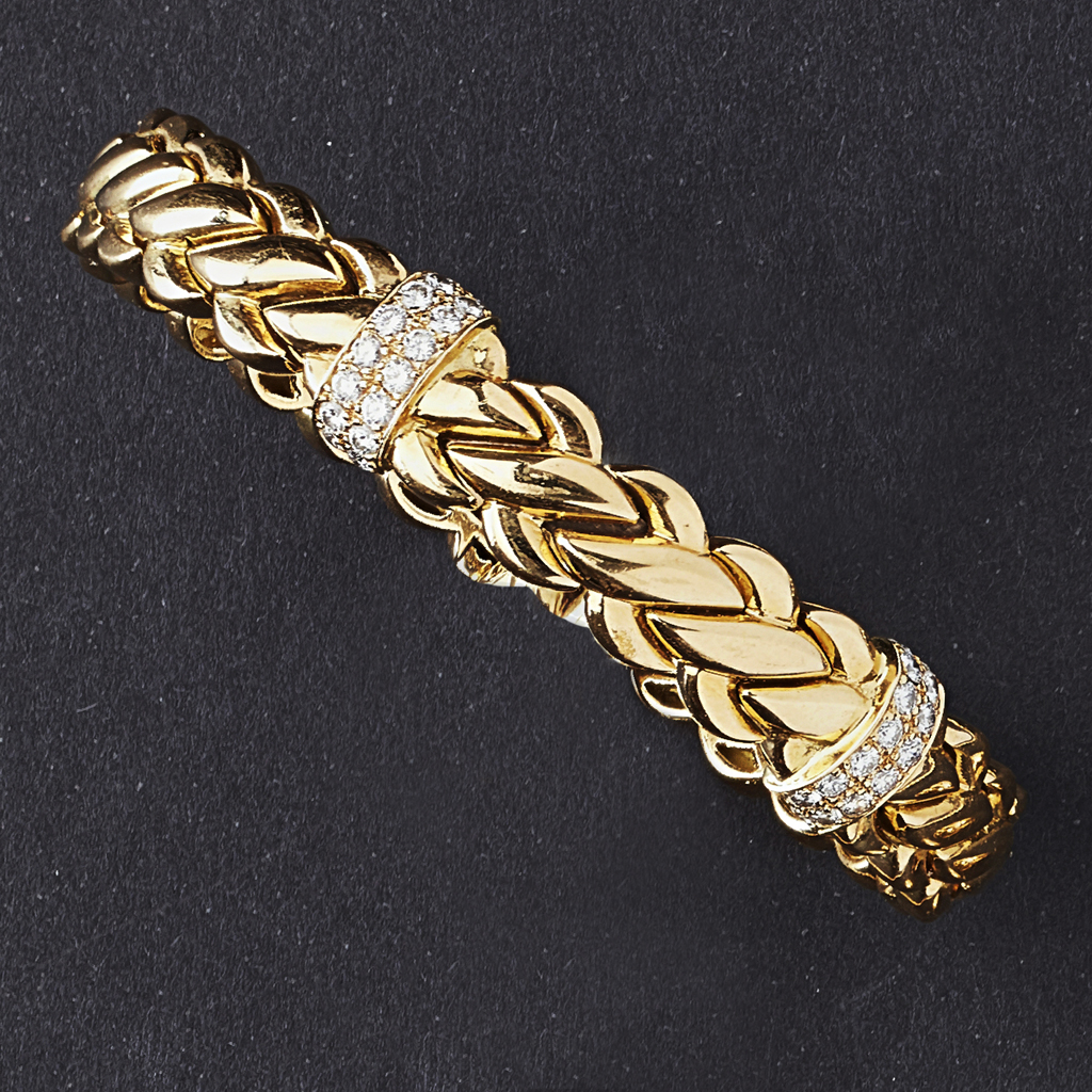 Appraisal: A diamond set braceletsprung composed of curved interlocking links with