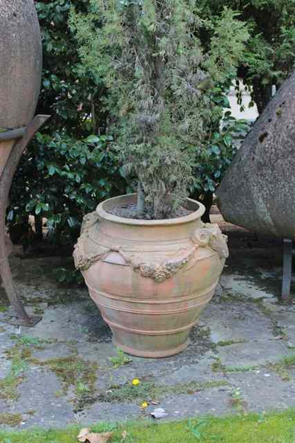 Appraisal: A SET OF THREE COMPOSITE OVOID URNS WITH RAMS MASK