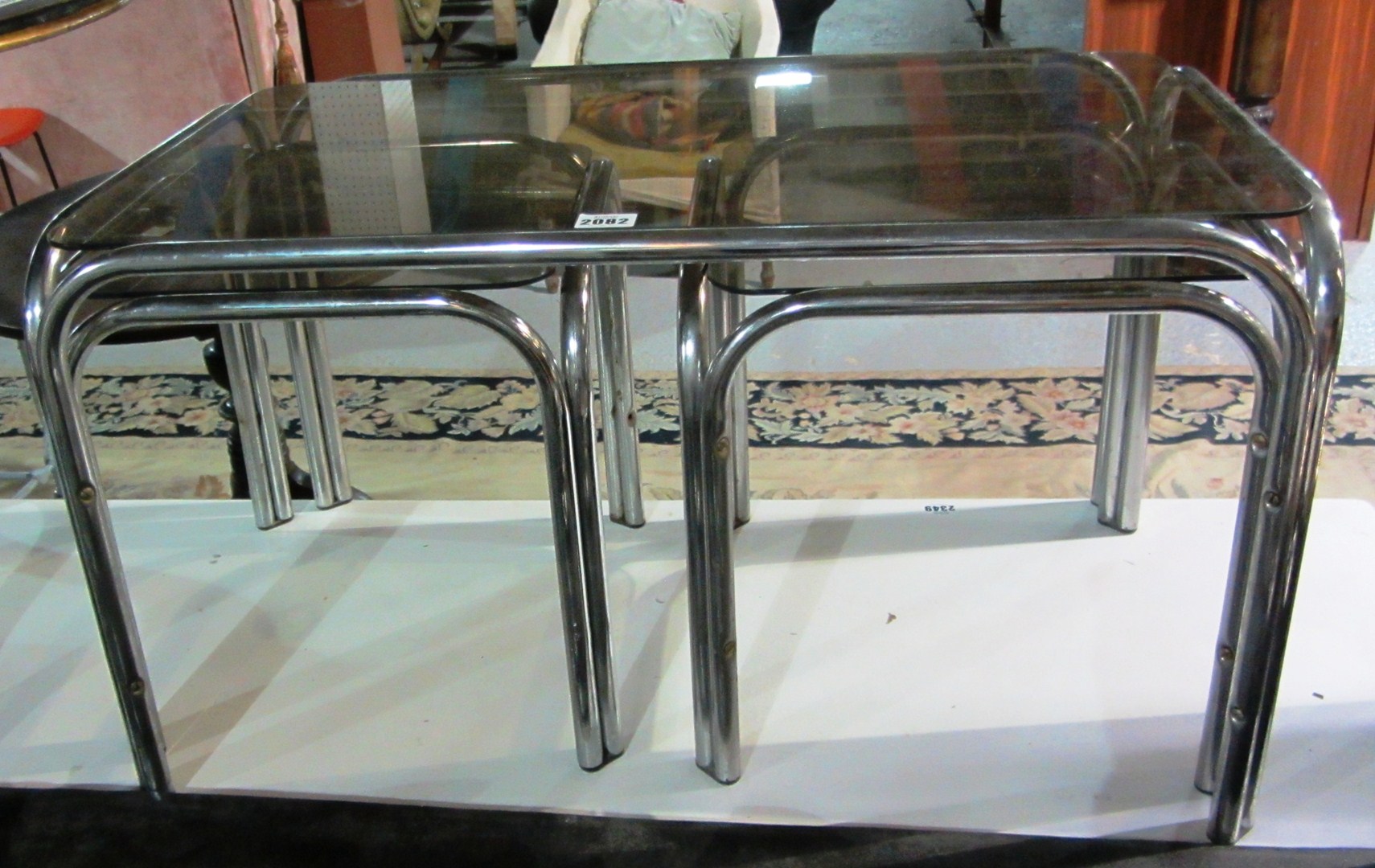 Appraisal: A nest of three steel and glass tables