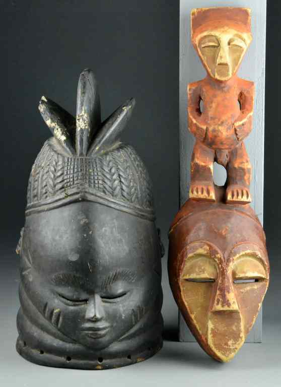 Appraisal: African Carved MasksTo include a very dark wood helmet style