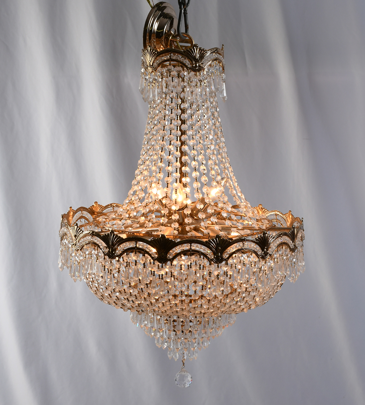 Appraisal: FRENCH LIGHT CRYSTAL CHANDELIER Gold toned folaite frame with draped